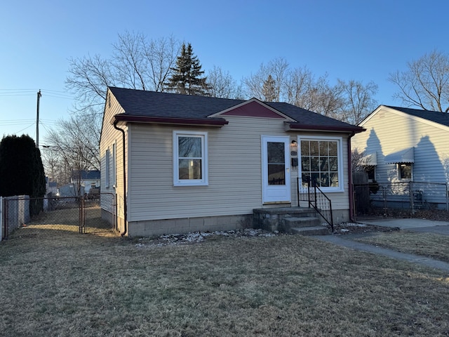 bungalow-style home with a front yard