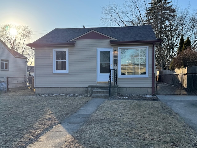 bungalow-style home with a yard