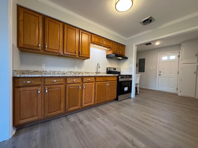 kitchen with ornamental molding, electric panel, stainless steel range oven, and light hardwood / wood-style floors