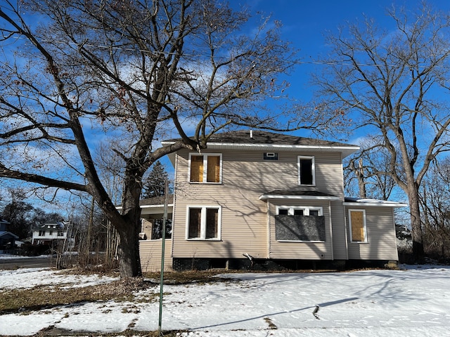 view of snow covered rear of property