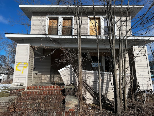 view of side of home featuring covered porch