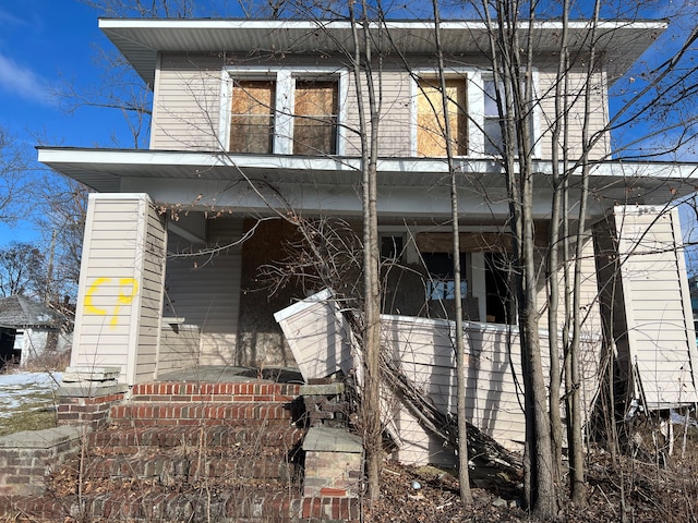 view of side of property with covered porch