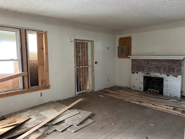 unfurnished living room with a textured ceiling and a fireplace