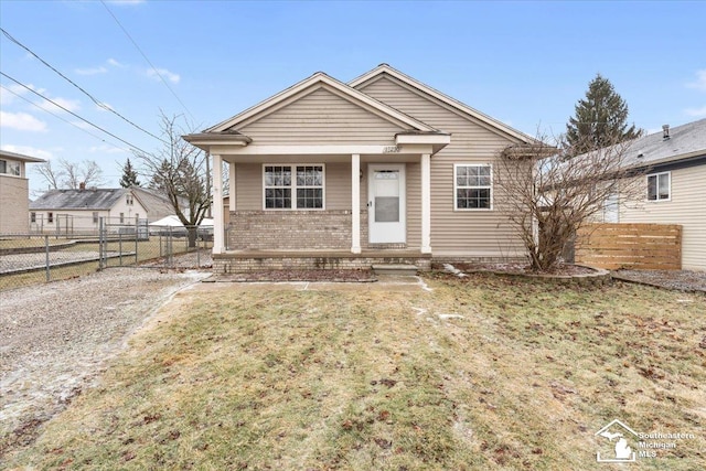 bungalow-style house with a front lawn and covered porch