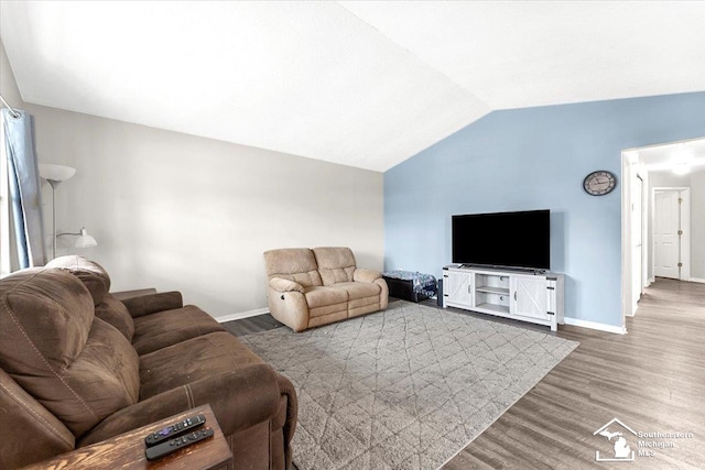 living room with hardwood / wood-style floors and vaulted ceiling