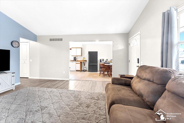 living room with lofted ceiling and wood-type flooring