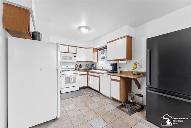 kitchen featuring white cabinetry, white appliances, and sink