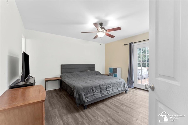 bedroom with access to exterior, wood-type flooring, and ceiling fan