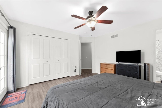 bedroom featuring hardwood / wood-style flooring, ceiling fan, and a closet