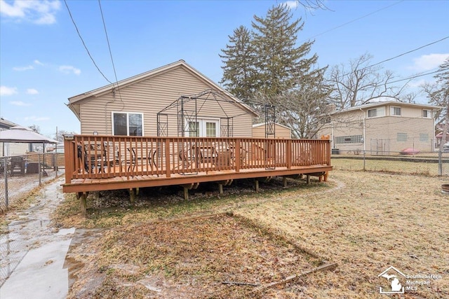 rear view of house with a wooden deck and a gazebo