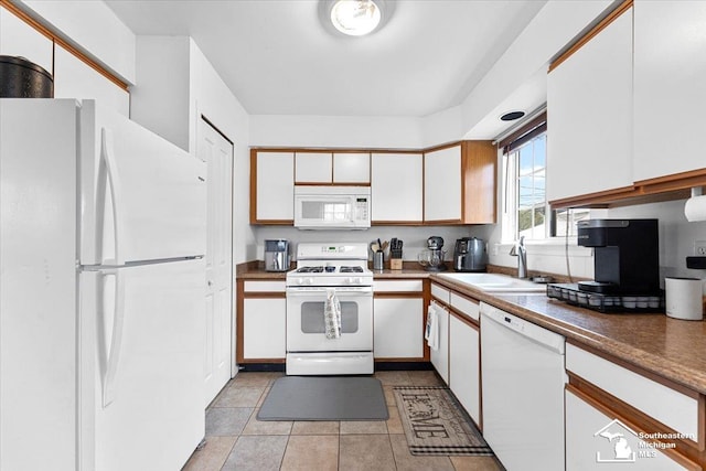 kitchen with white cabinetry, white appliances, sink, and light tile patterned floors