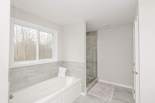 53188 Woodland Mdws, Chesterfield, MI 48047 - full bathroom with visible vents, a shower stall, a bath, and baseboards