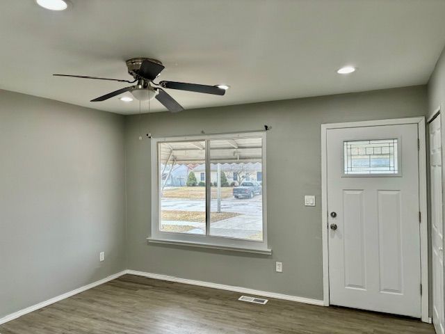 foyer entrance featuring ceiling fan and dark hardwood / wood-style flooring