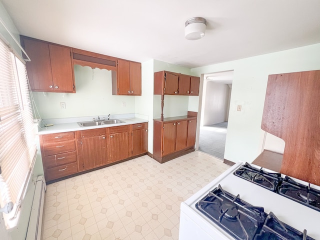 kitchen featuring white gas range and sink