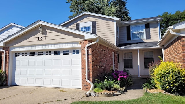 traditional home featuring brick siding, a garage, and concrete driveway