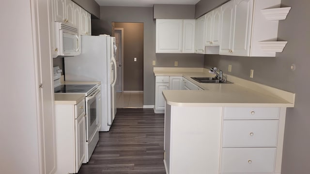 kitchen featuring white cabinetry, sink, white appliances, and kitchen peninsula