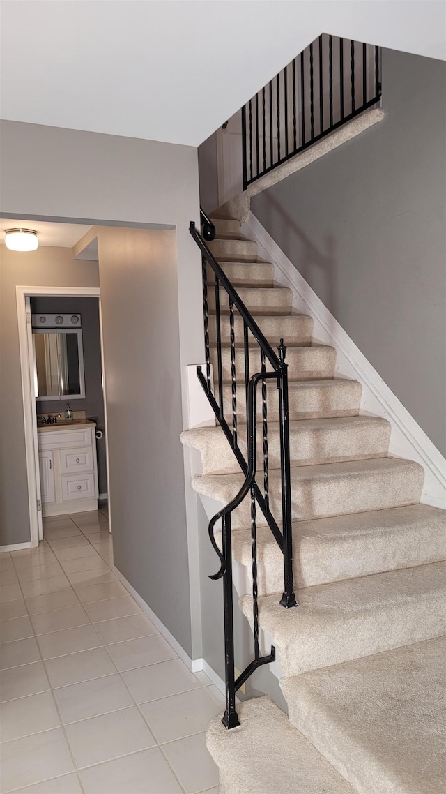 staircase with tile patterned flooring and baseboards