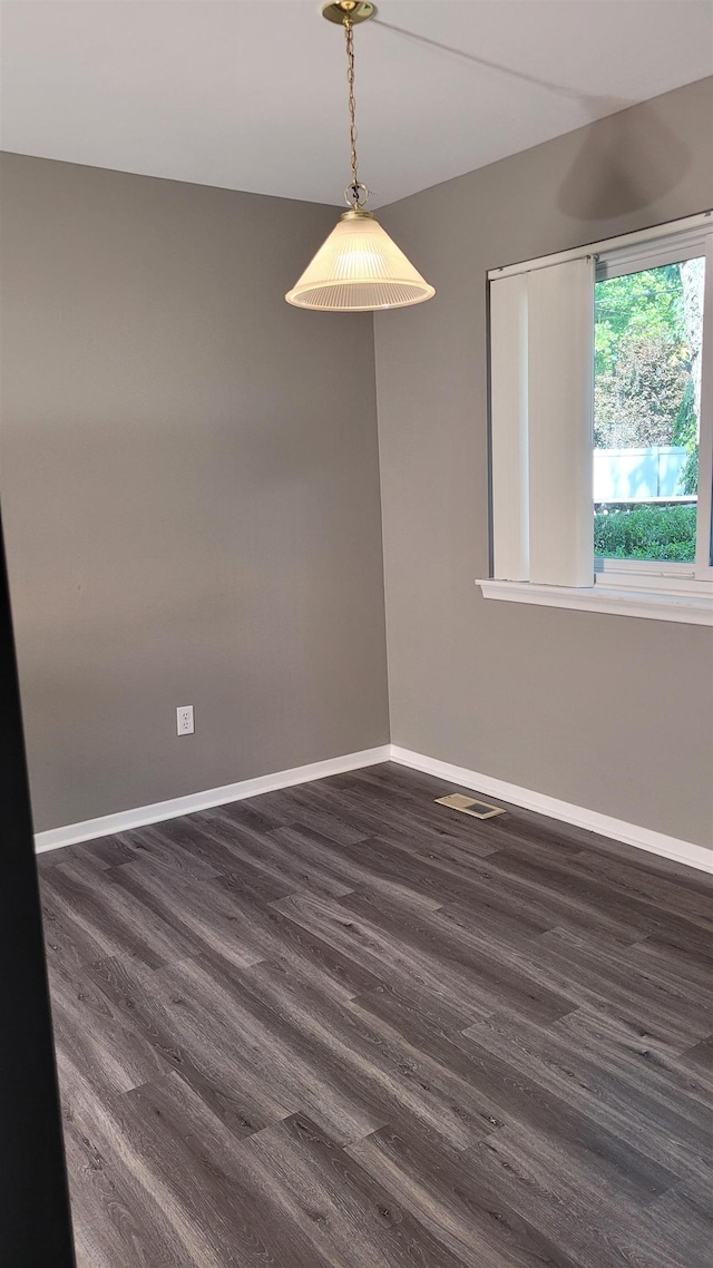 empty room featuring dark wood-type flooring