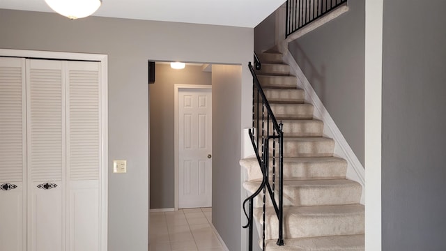 stairs with tile patterned flooring and baseboards