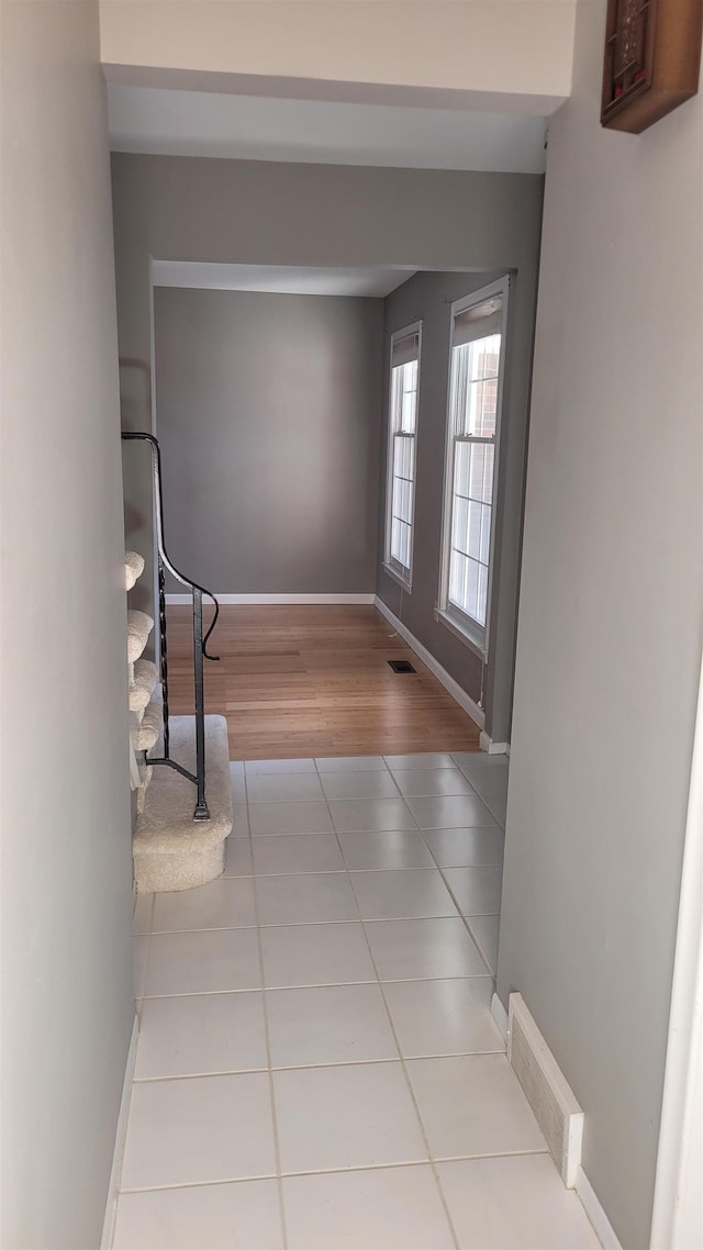 corridor with light tile patterned floors