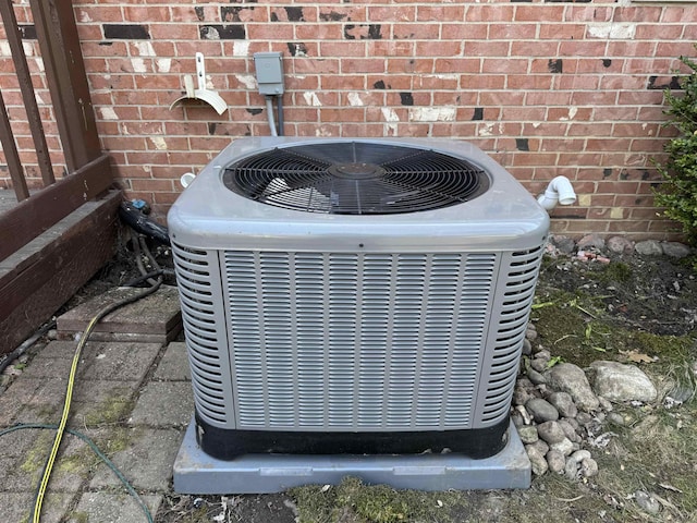 exterior view of cooling unit and brick siding