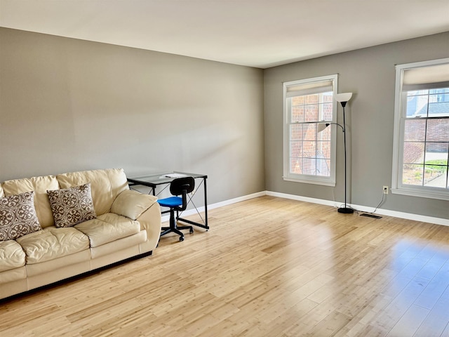 office with baseboards and wood finished floors