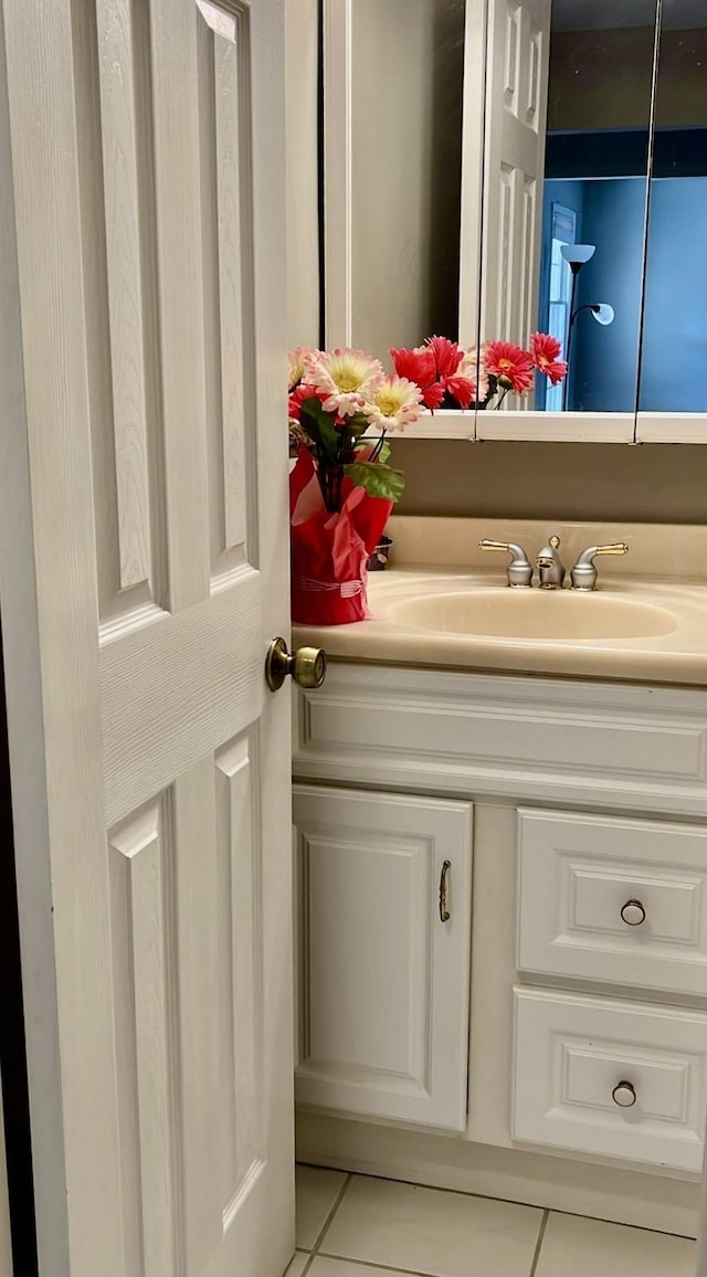 bathroom with tile patterned floors and vanity
