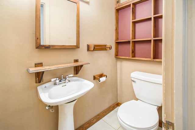 bathroom with sink, toilet, and tile patterned flooring