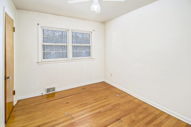 empty room with hardwood / wood-style flooring and ceiling fan