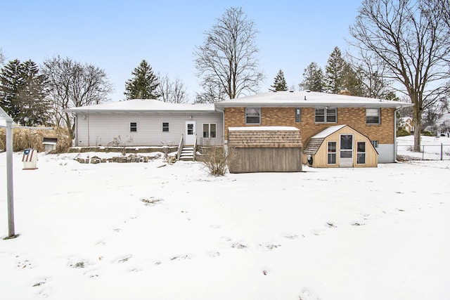 view of snow covered rear of property