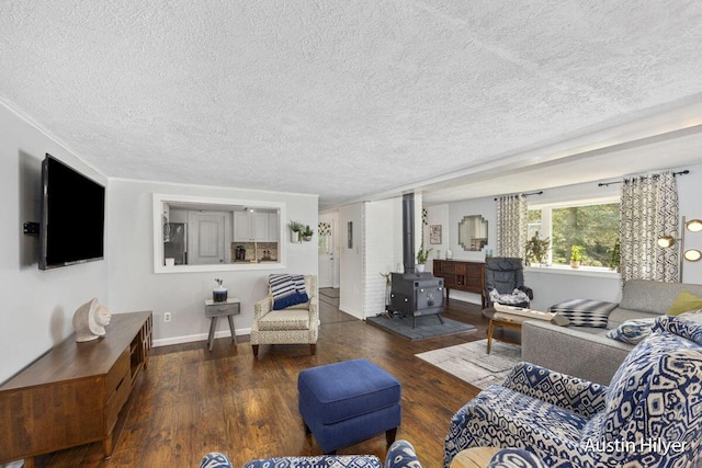 living room featuring dark hardwood / wood-style flooring, a textured ceiling, and a wood stove