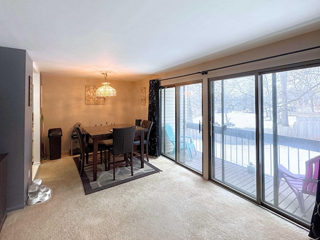 dining area featuring light colored carpet