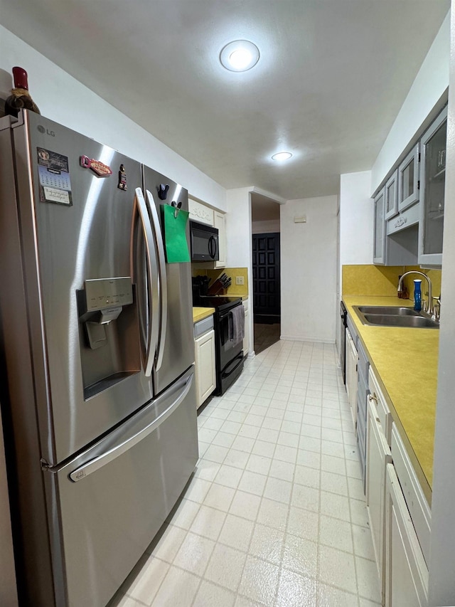 kitchen featuring gray cabinetry, sink, and black appliances