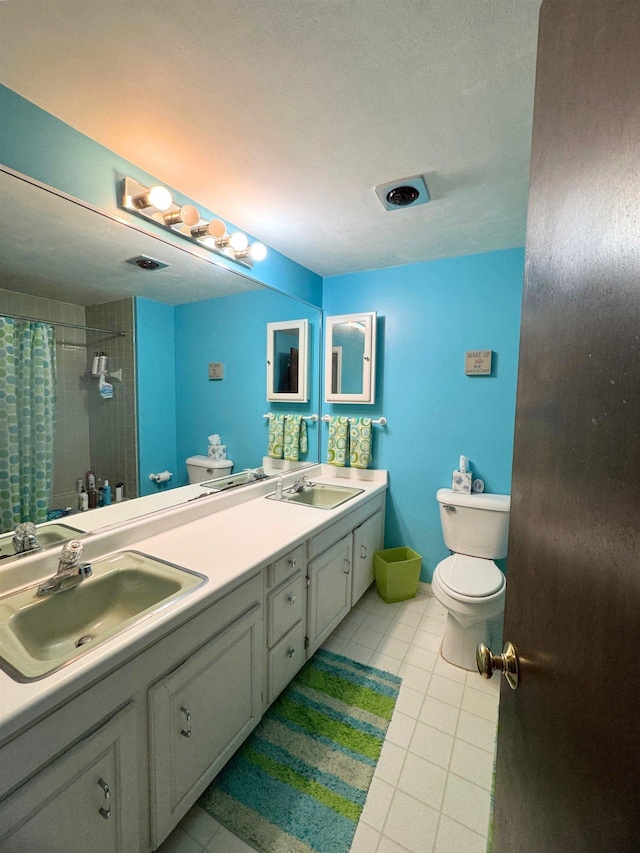 bathroom with walk in shower, tile patterned floors, vanity, and toilet