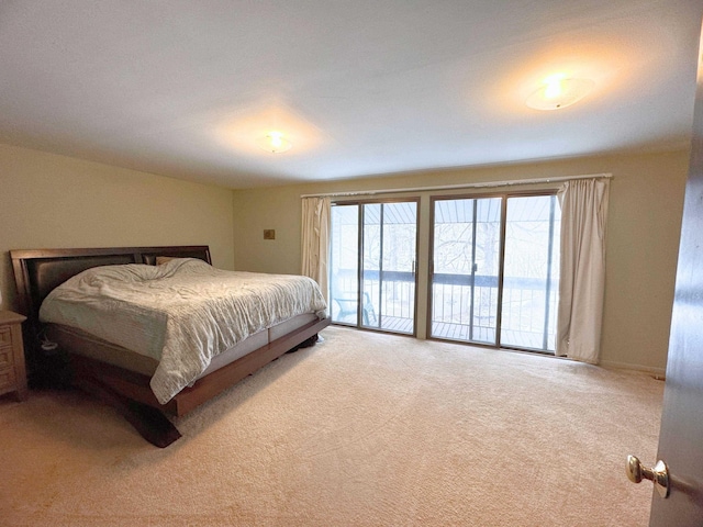 bedroom with multiple windows, access to exterior, and light carpet