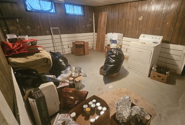 basement featuring washer / dryer and wooden walls