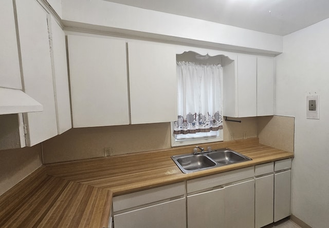 kitchen featuring sink and white cabinets