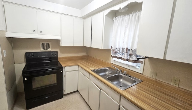 kitchen with white cabinetry, sink, and black / electric stove