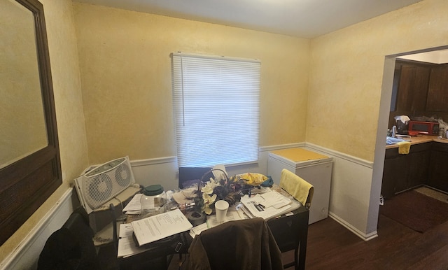 dining area with a wall mounted air conditioner and dark wood-type flooring