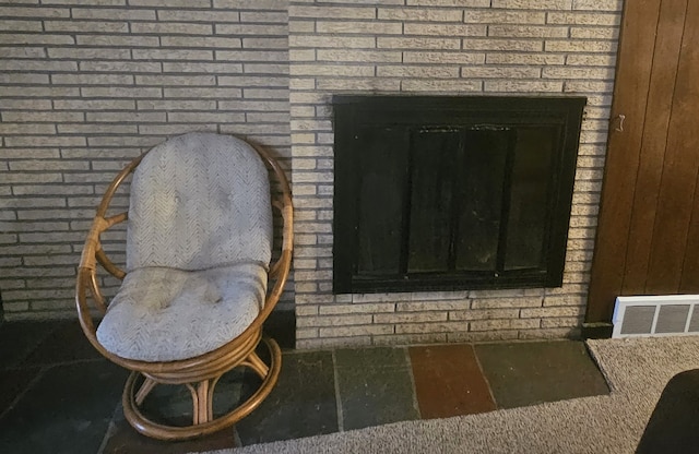 interior details featuring a brick fireplace