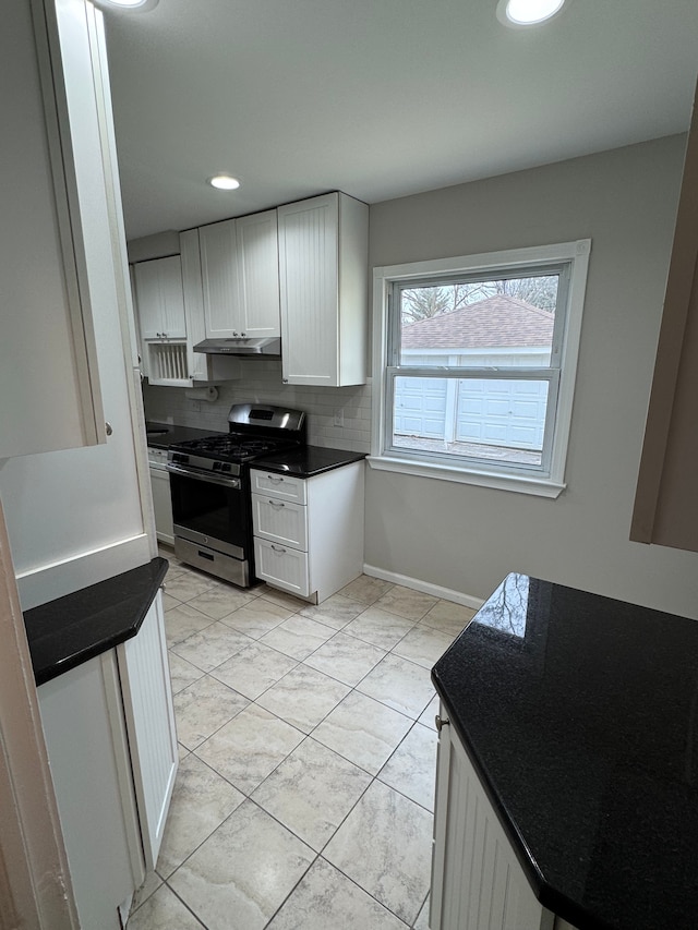 kitchen featuring white cabinetry, stainless steel gas range, tasteful backsplash, and light tile patterned floors