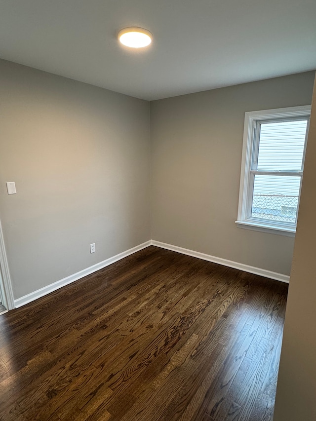 spare room with dark wood-type flooring