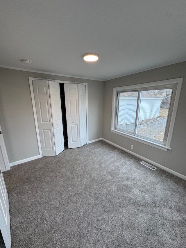 unfurnished bedroom featuring a closet and carpet