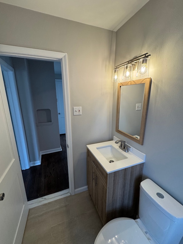 bathroom featuring hardwood / wood-style flooring, vanity, and toilet