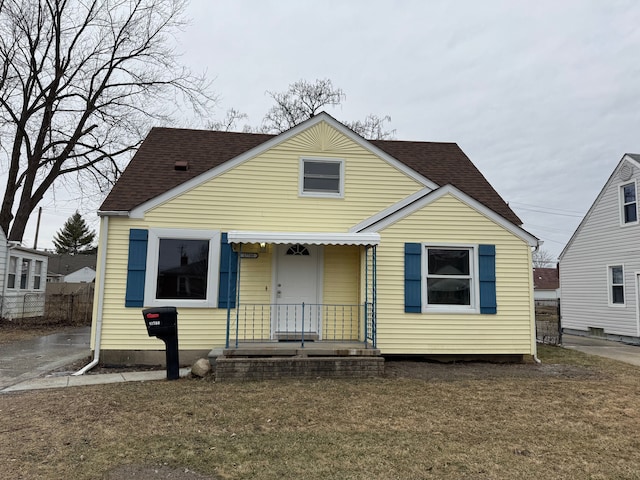 bungalow-style home with a front yard