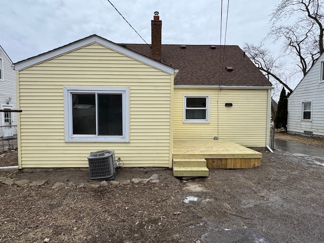 back of property with a deck and central air condition unit