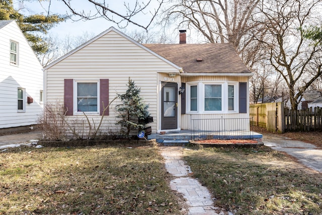 bungalow-style house featuring a front yard