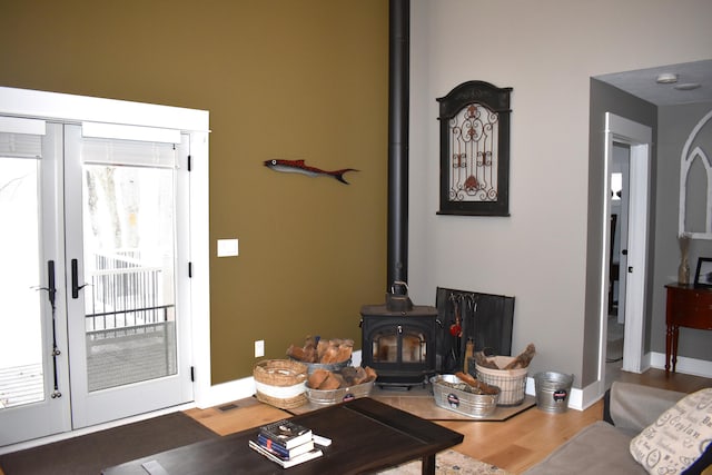 living room featuring a wood stove and hardwood / wood-style floors