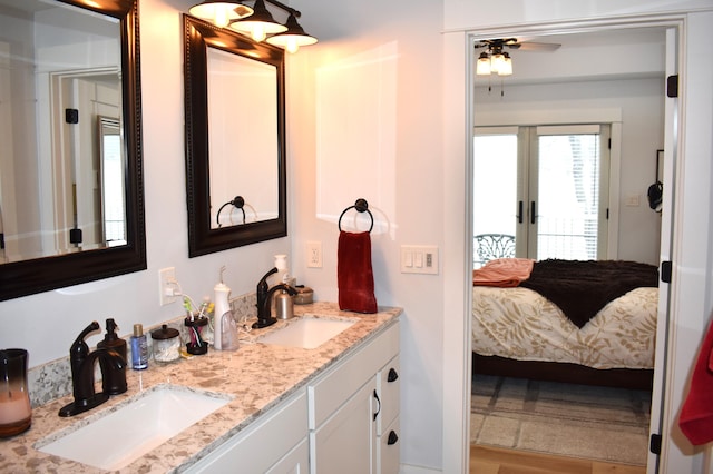 bathroom featuring vanity, ceiling fan, and french doors