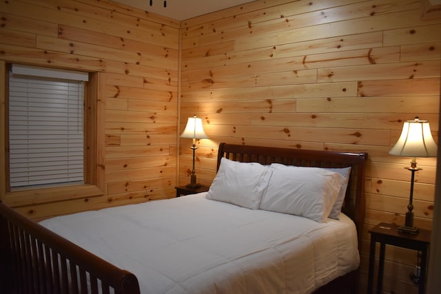 bedroom with wooden walls